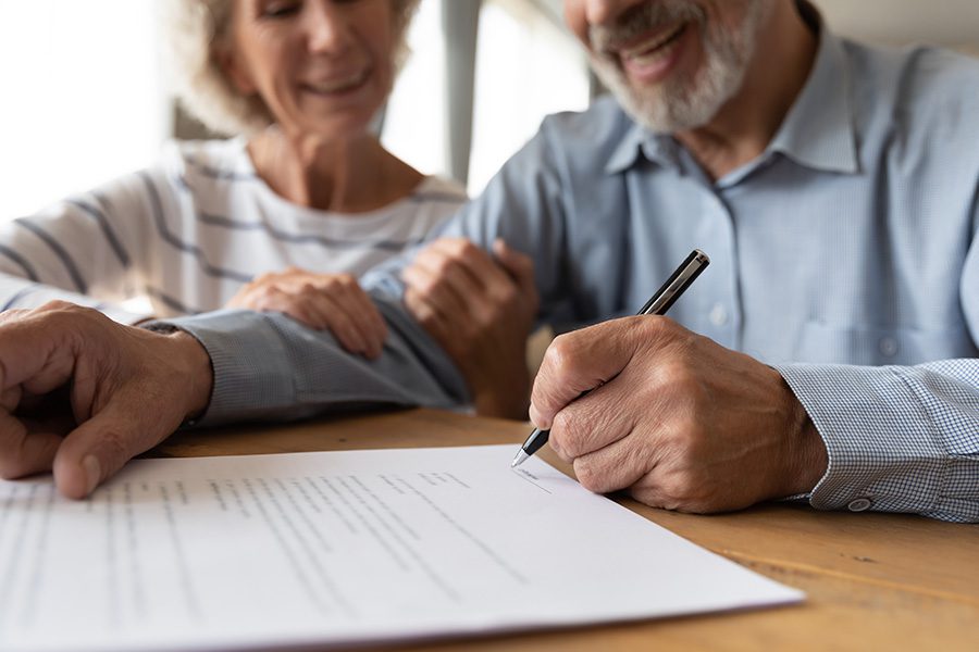 ACA and Short-Term Medical Plans - Close up of a Husband and Wife at a Desk and Smiling