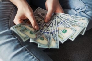 Blog - Hands Fanning A Collection of Hundred Dollar Bills